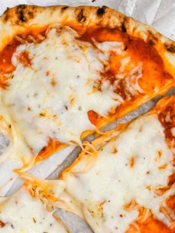 close up shot of naan bread pizza on white background.