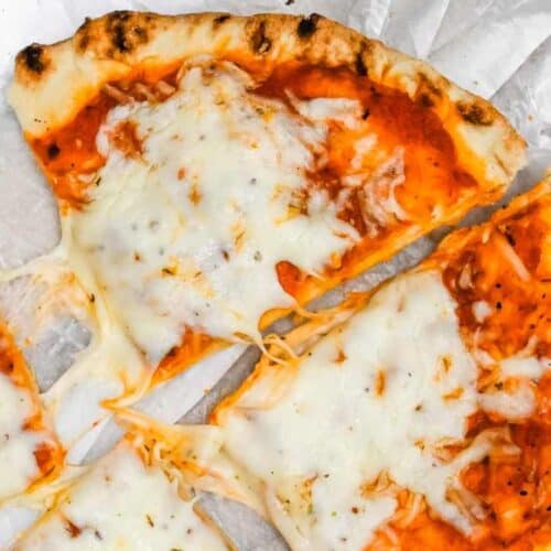 close up shot of naan bread pizza on white background.