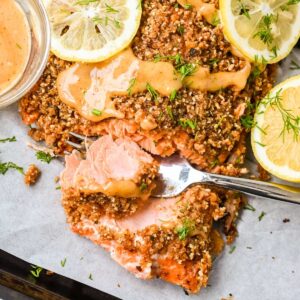featured image for this almond crusted salmon recipe showing closeup of fish flaking on a fork.